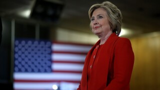 Hillary Clinton stands on a stage.