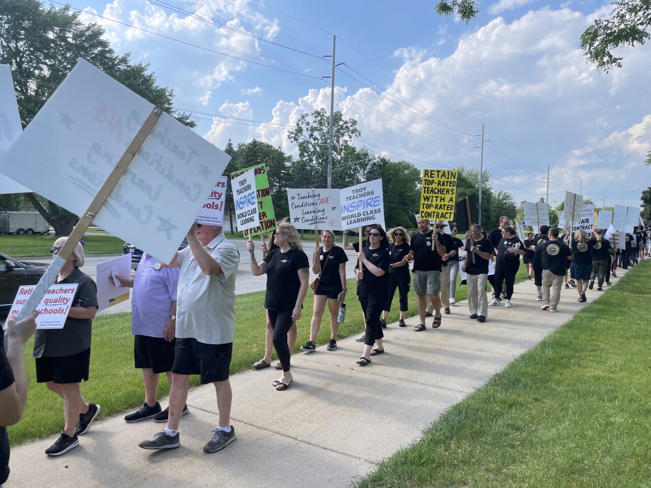 More than 150 teachers and parents with the Troy School District picket outside the school administration building on May 21, 2024.