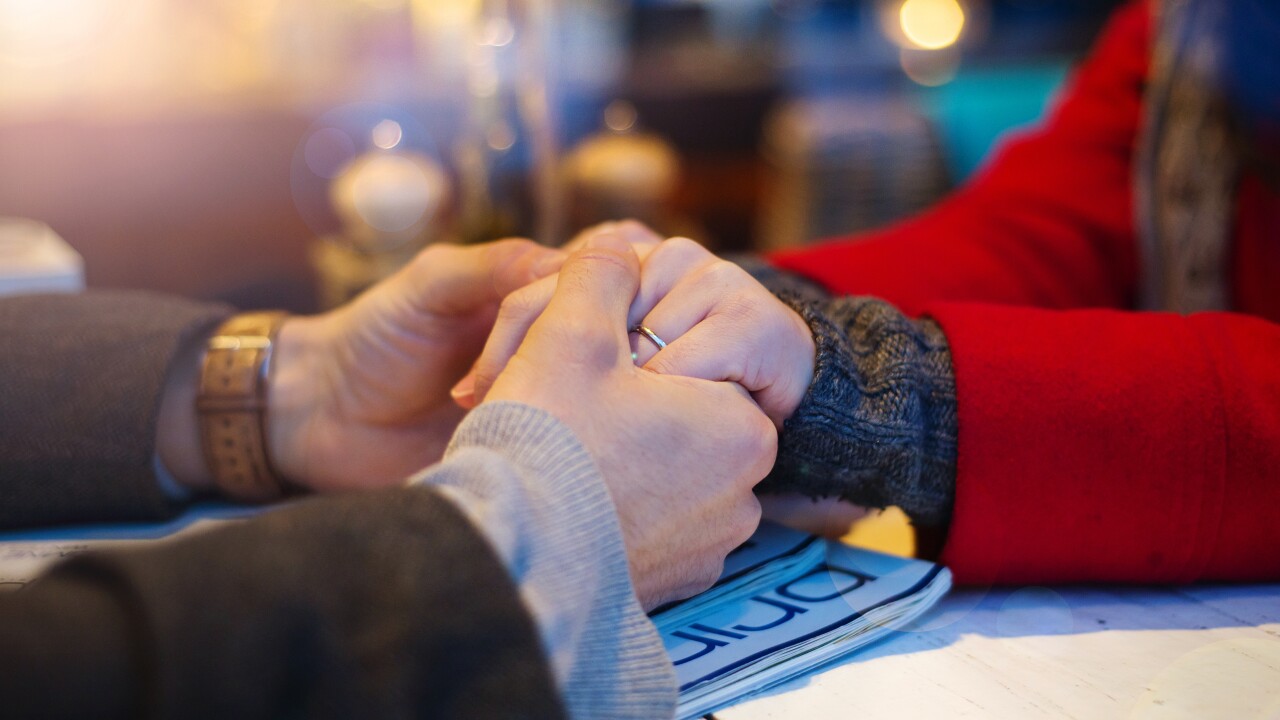 Couple in cafe holding each other's hand