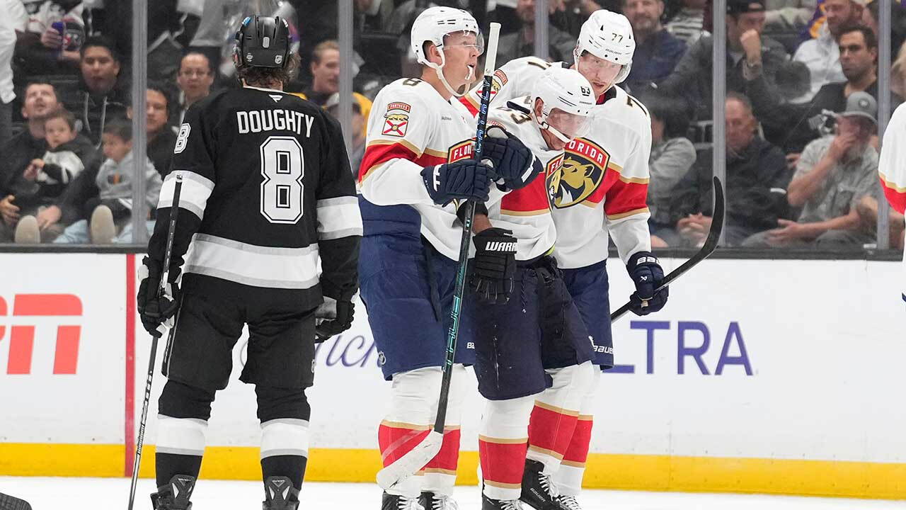 Florida Panthers left wing Brad Marchand, second from right, is helped off the ice by left wing Brady Tkachuk, second from left, and defenseman Niko Mikkola after he was injured as Los Angeles Kings defenseman Drew Doughty looks on during the second period of an NHL hockey game Tuesday, Oct. 6, 2026, in Los Angeles.