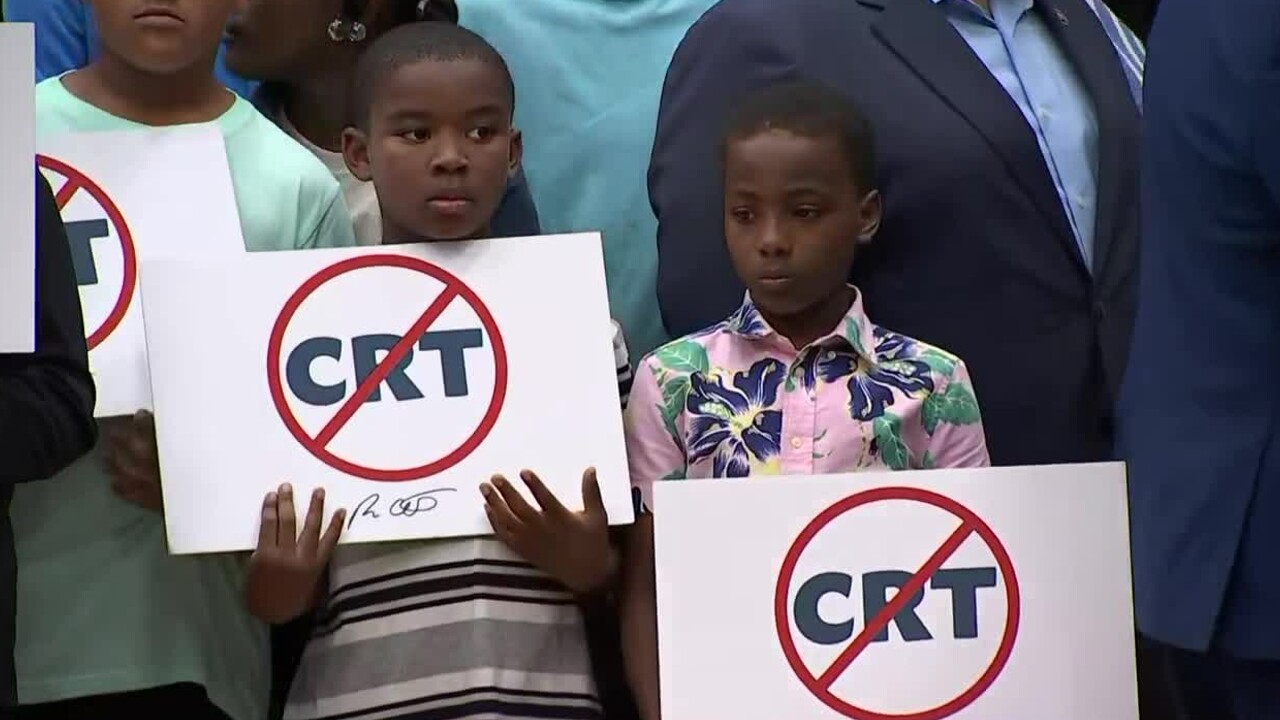 Black students hold anti-critical race theory signs at Mater Academy Charter Middle/High School in Hialeah Gardens on April 22, 2022