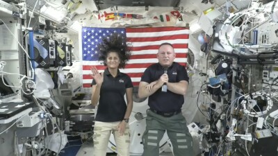 Astronauts Suni Williams, left, and Butch Wilmore give a news conference aboard the International Space Station.