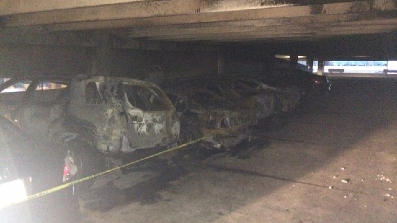 Overnight parking garage fire destroys five cars
