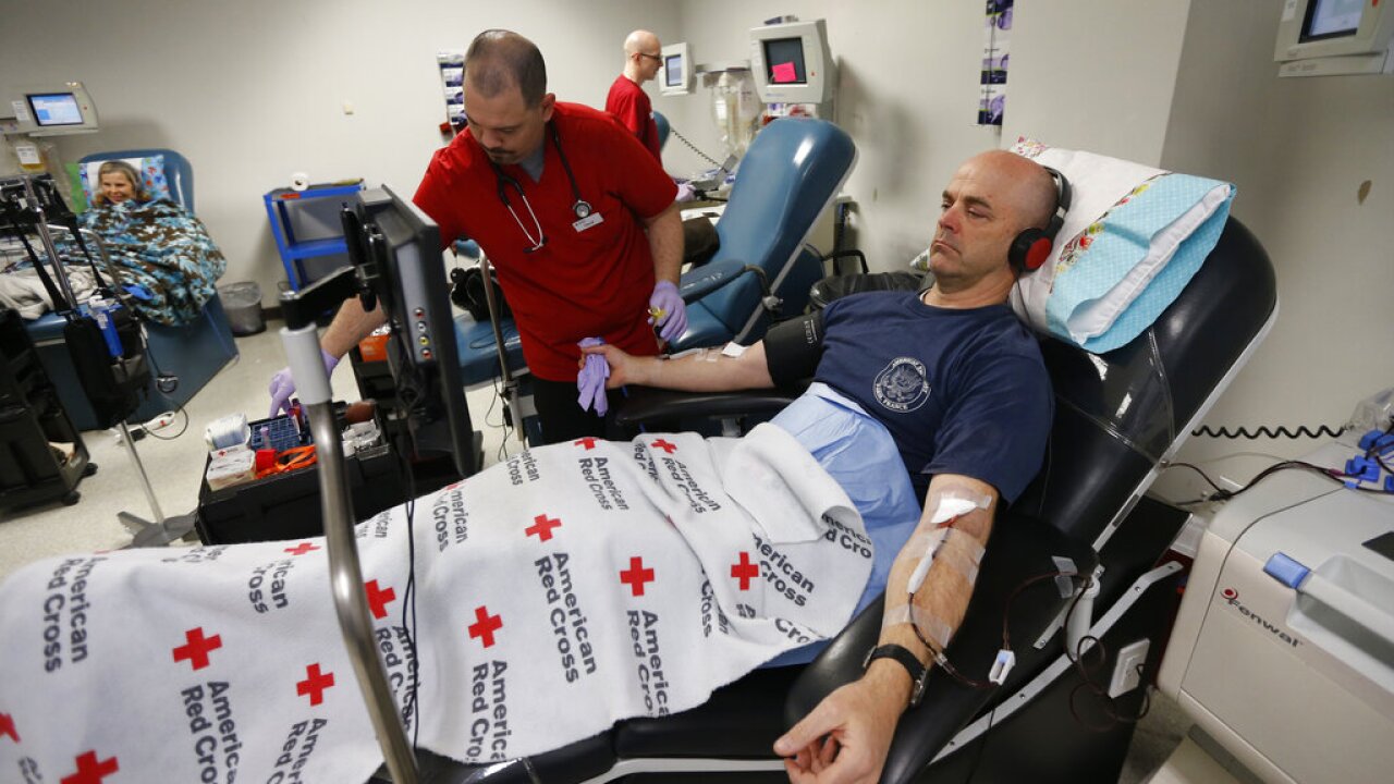 A man gives blood at the American Red Cross Donation Center in Murray, Utah. 