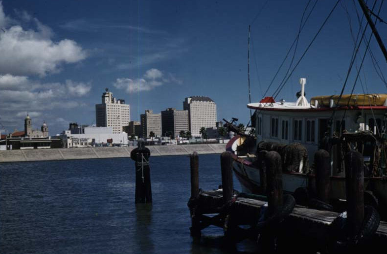 1950s - Boat Docked Next to a Small Pier.png
