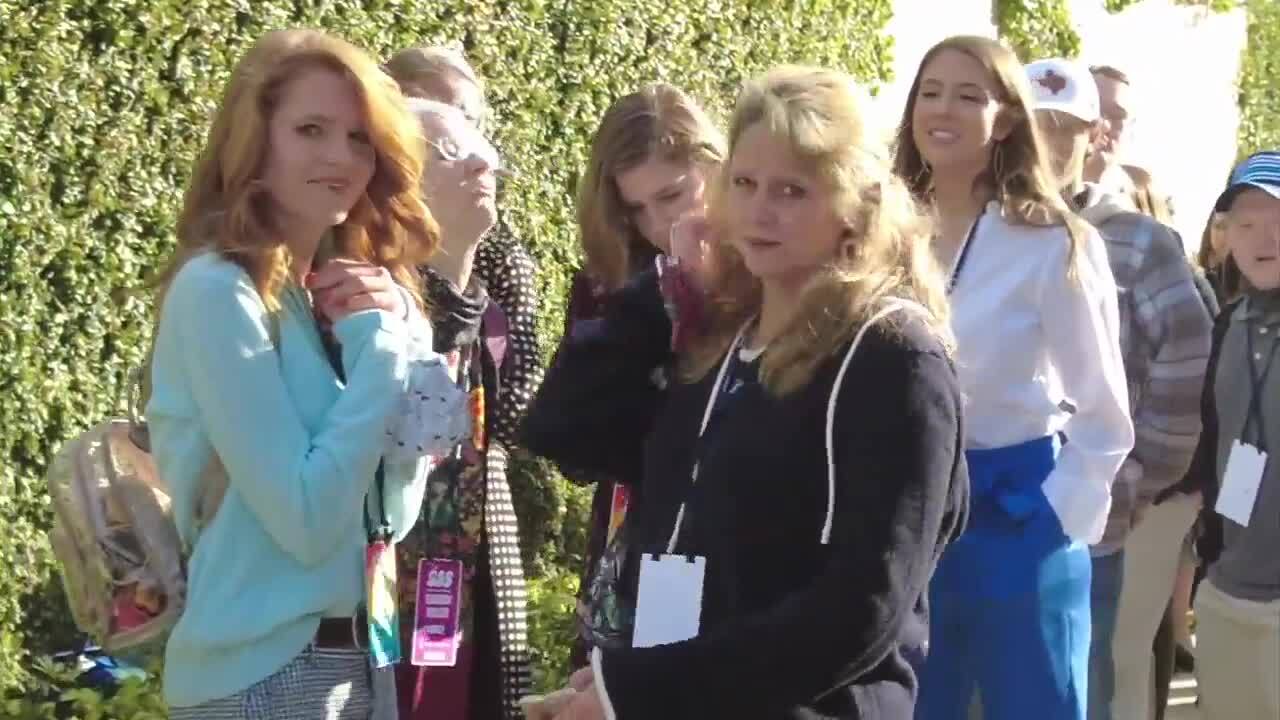 Maskless group of individuals wait in line to attend Turning Point USA conference, Dec. 22, 2020