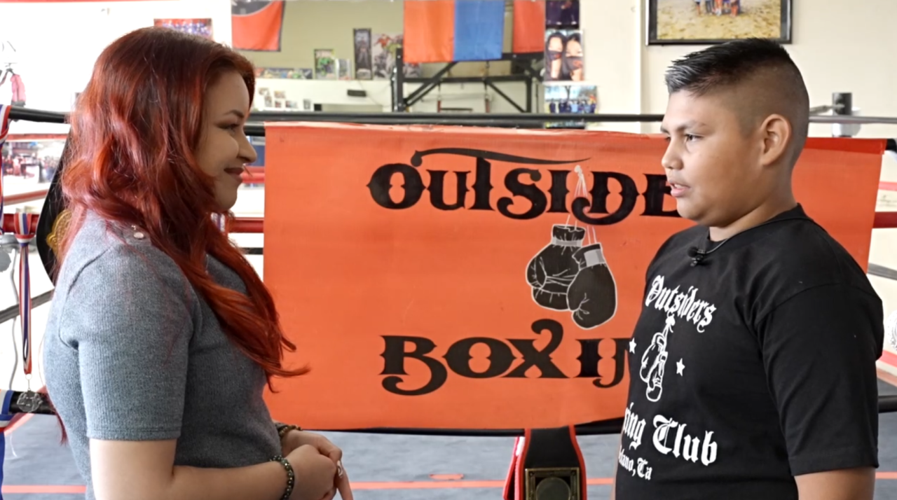 Neighborhood News Reporter Ruby Rivera interviewing boxer, Mateo Ramos