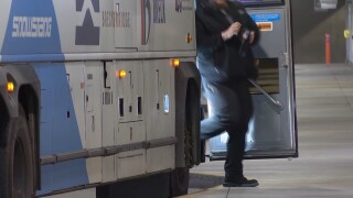 Man stepping off public transportation bus for passengers