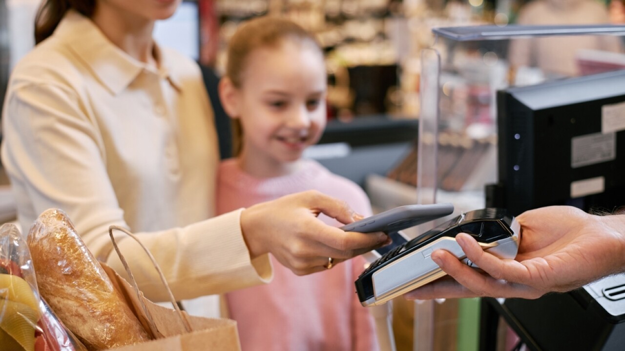 Smiling,Woman,Making,Payment,At,Store,Counter,With,Child,Happily