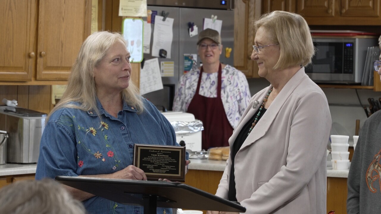 Vicki receiving a plaque for her 32 years of teaching