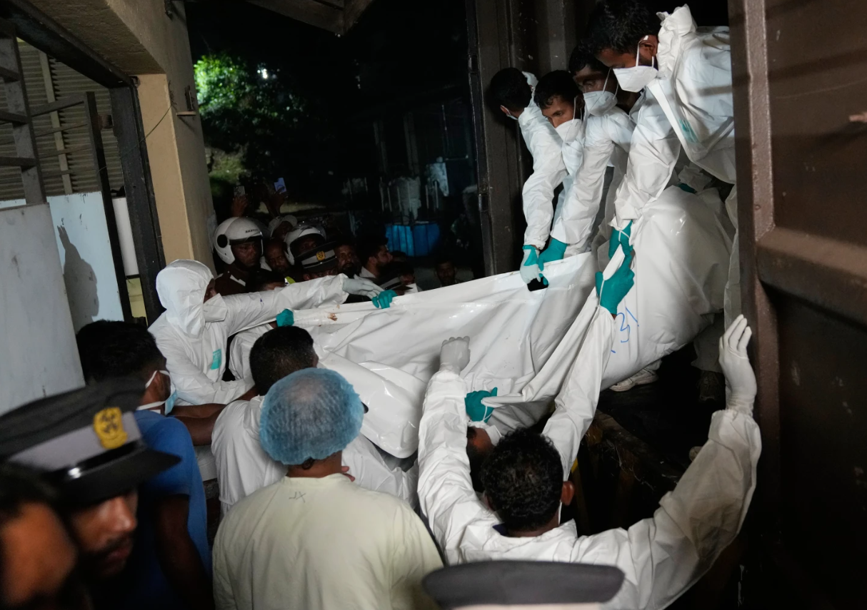 Health care workers unload from a vehicle, the bodies of Iranian sailors who died when their IRIS Dena warship sank outside Sri Lanka's territorial waters, in Galle, Sri Lanka, Wednesday, March 4, 2026.