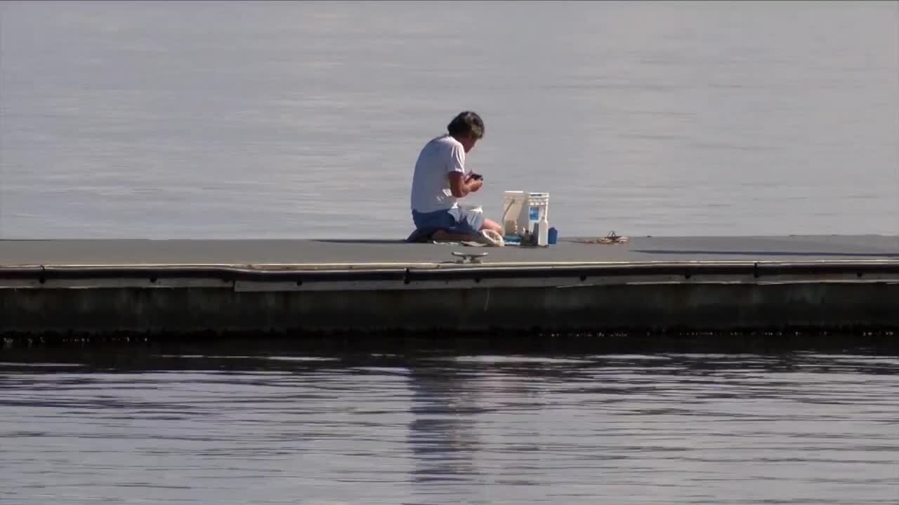 man tests water in St. Lucie Estuary