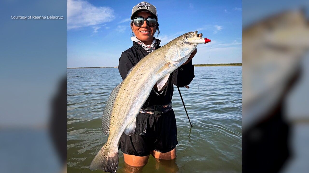 Captain Reanna Delacruz posing with a trophy speckled trout