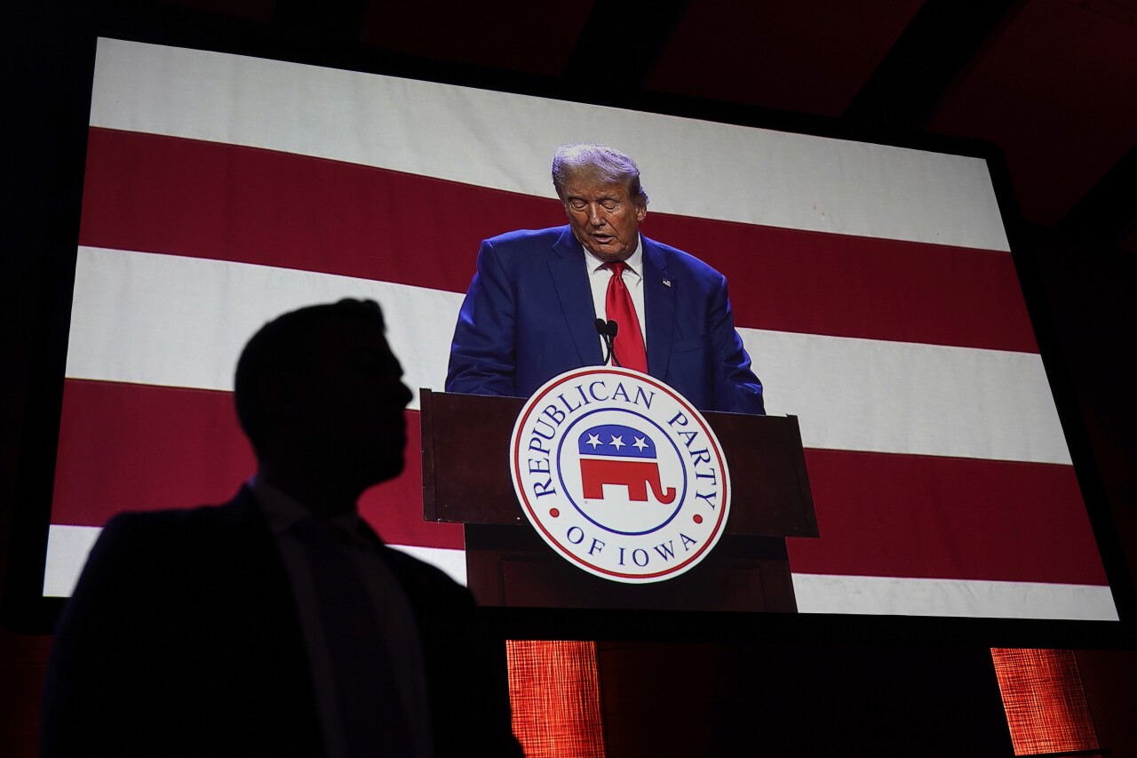 A U.S. Secret Service agent watches former president Donald Trump speak on a monitor at the Republican Party of Iowa's 2023 Lincoln Dinner in Des Moines, Iowa, Friday, July 28, 2023. (AP Photo/Charlie Neibergall)