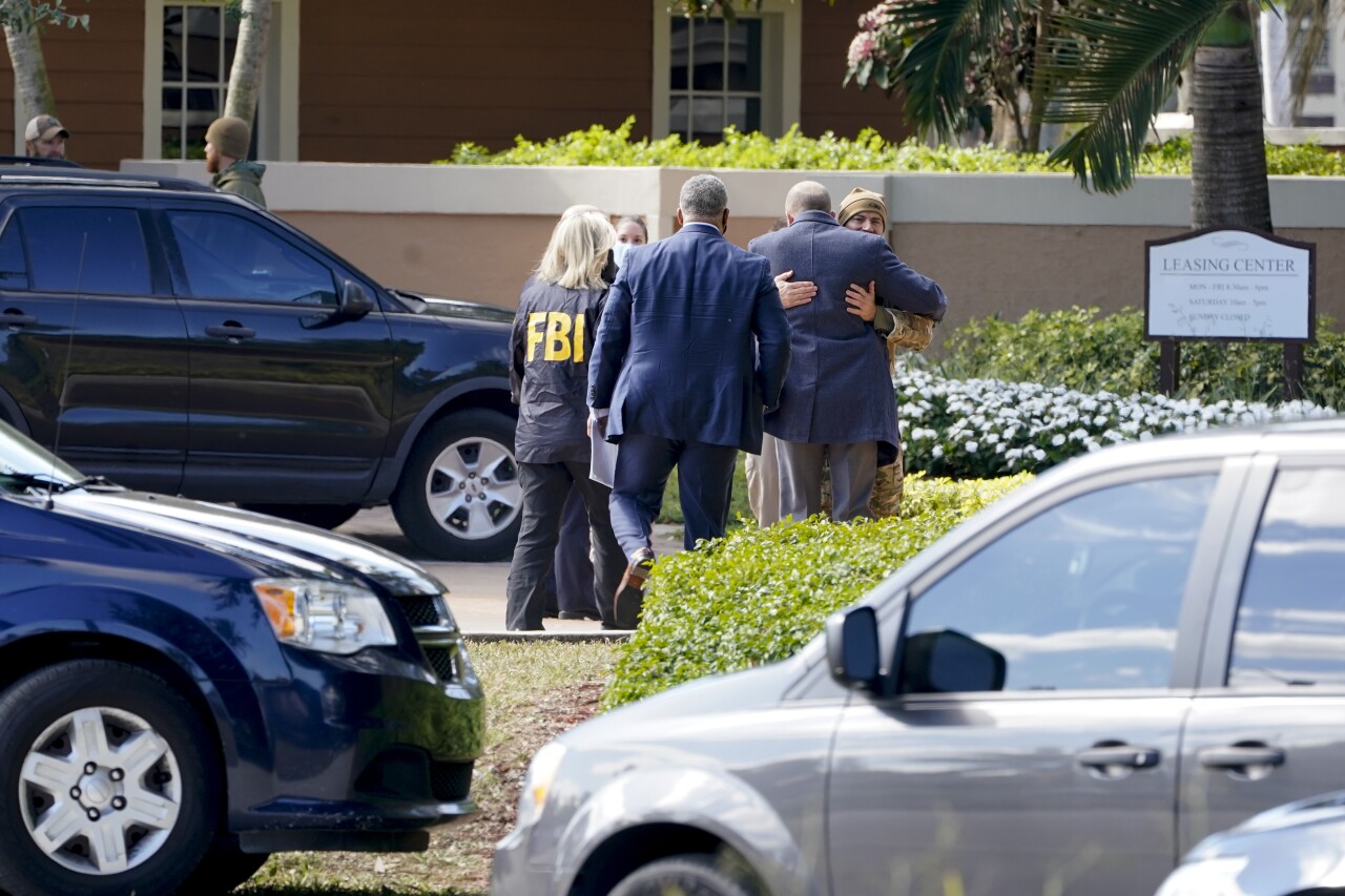 Law enforcement embrace outside scene of FBI shooting in Sunrise