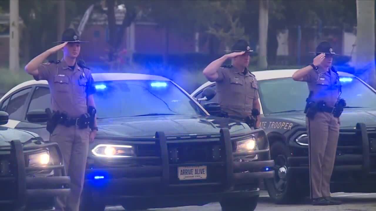 FHP troopers salute as body of FWC officer killed in crash passes by