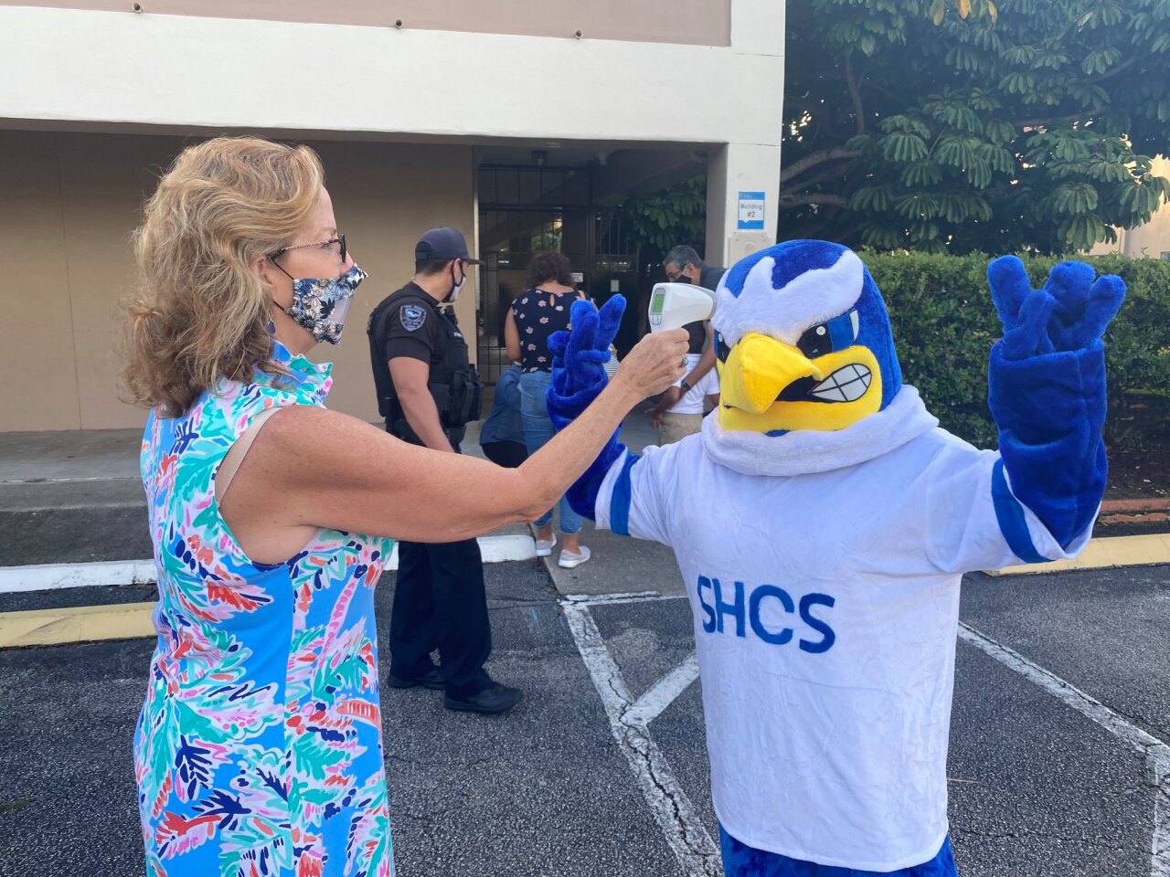St. Helen Catholic School teacher conducts temperature check of Eagle mascot