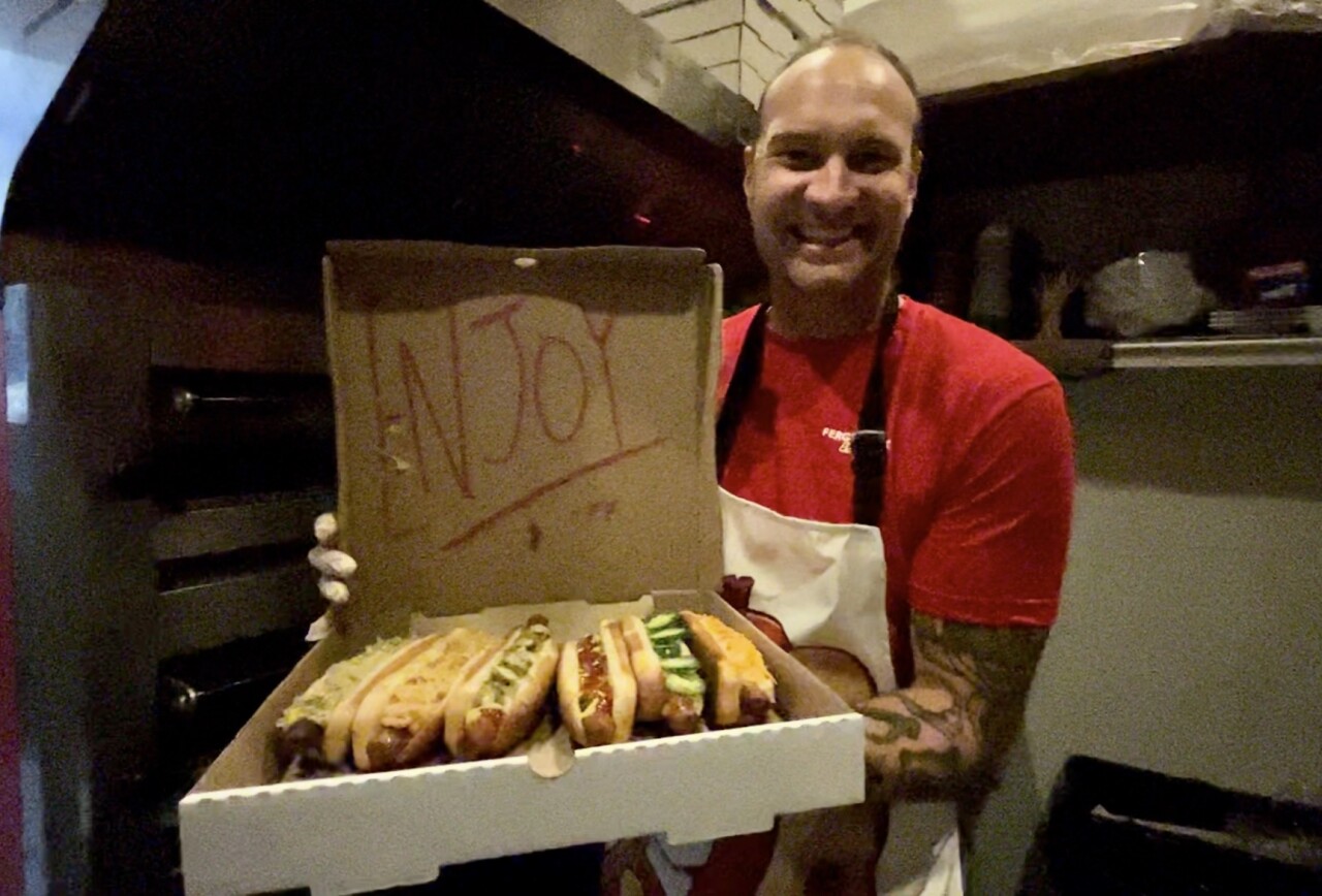 Employee Reed Ferguson shows off a variety of hot dogs at 123 Datura in West Palm Beach on July 19, which is National Hot Dog Day. 2023