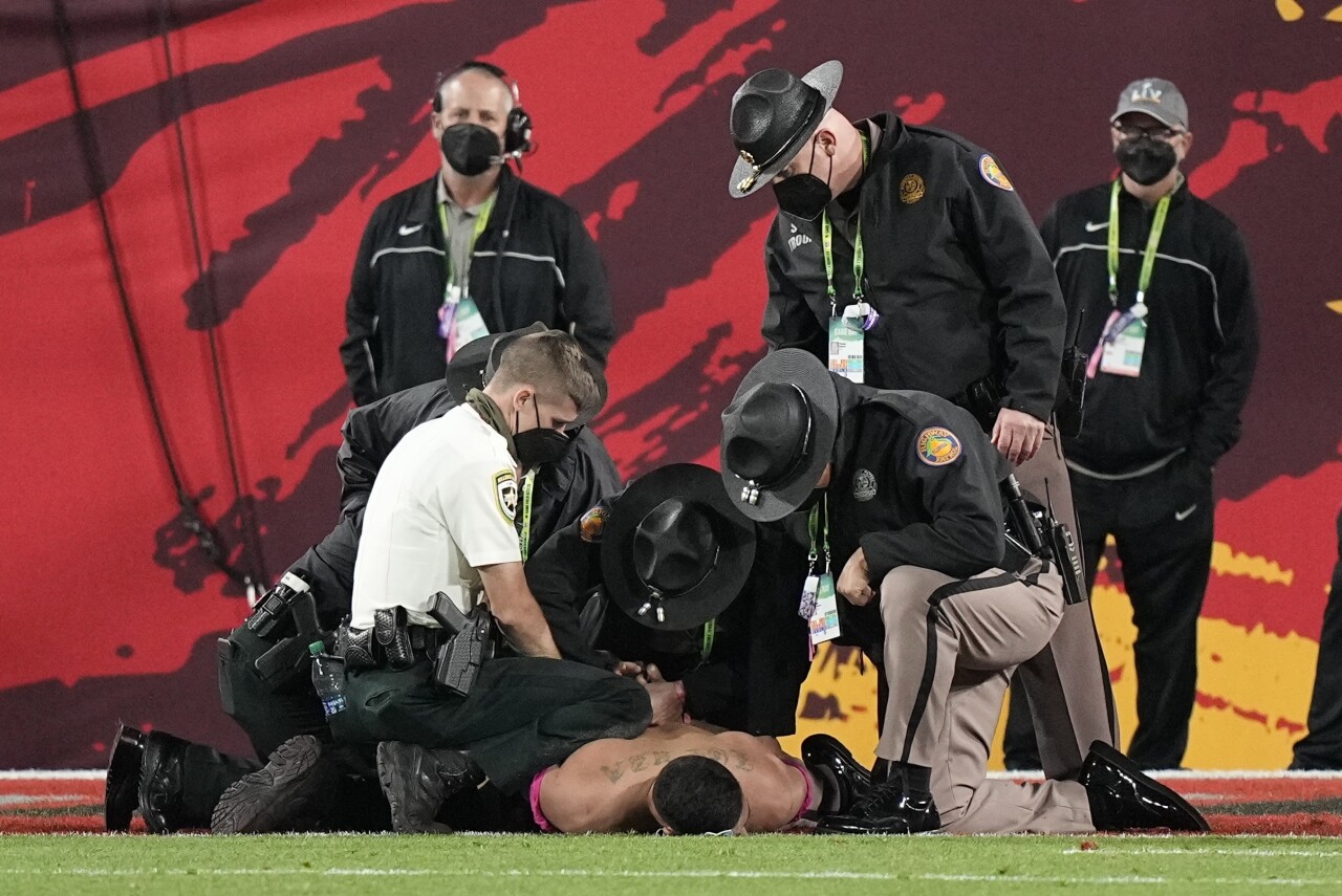 Authorities apprehend Yuri Andrade after he ran onto field during Super Bowl LV