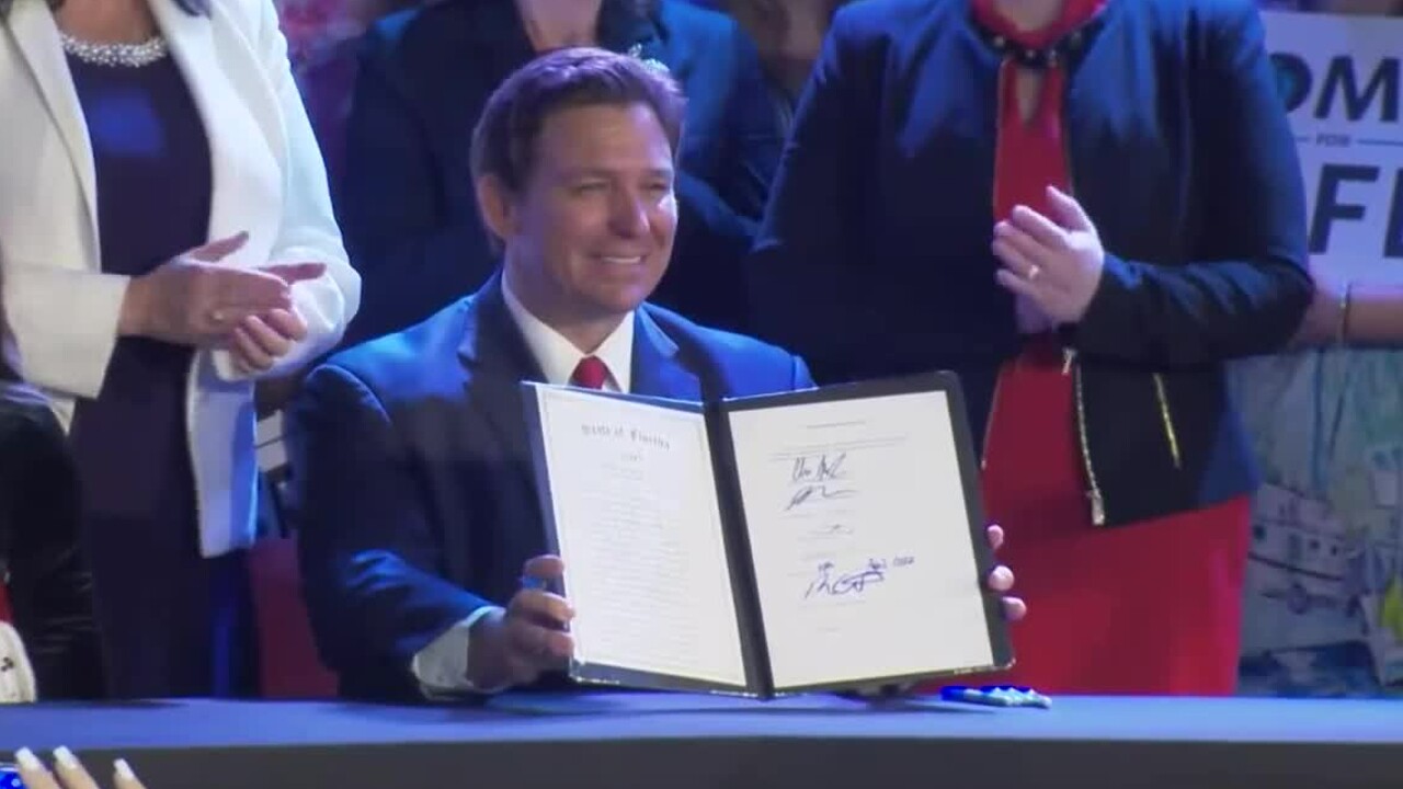 Florida Gov. Ron DeSantis signs the 'Reducing Fetal and Infant Mortality' bill into law in Kissimmee on April 14, 2022.jpg