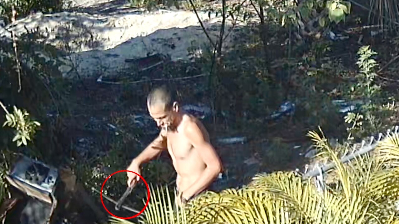 Man next door with what looks like a handgun