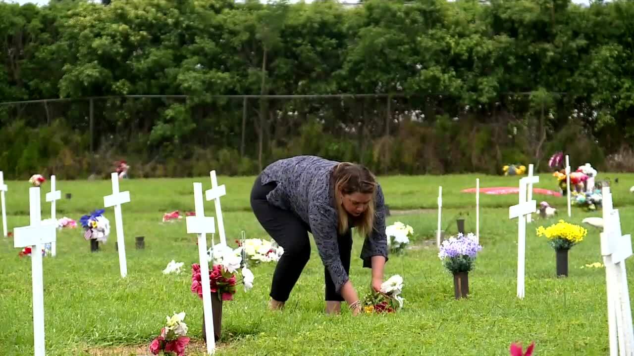 Margaret Garetano-Castor places flowers on gravesite of Karen Slattery