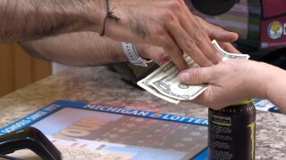 Cashier gives back change to customer