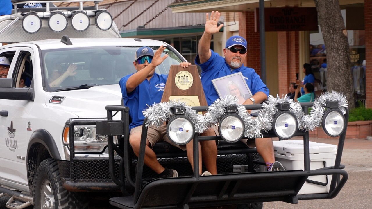 Santa Gertrudis Academy's Thomas De Los Santos holds late mother's picture on State parade