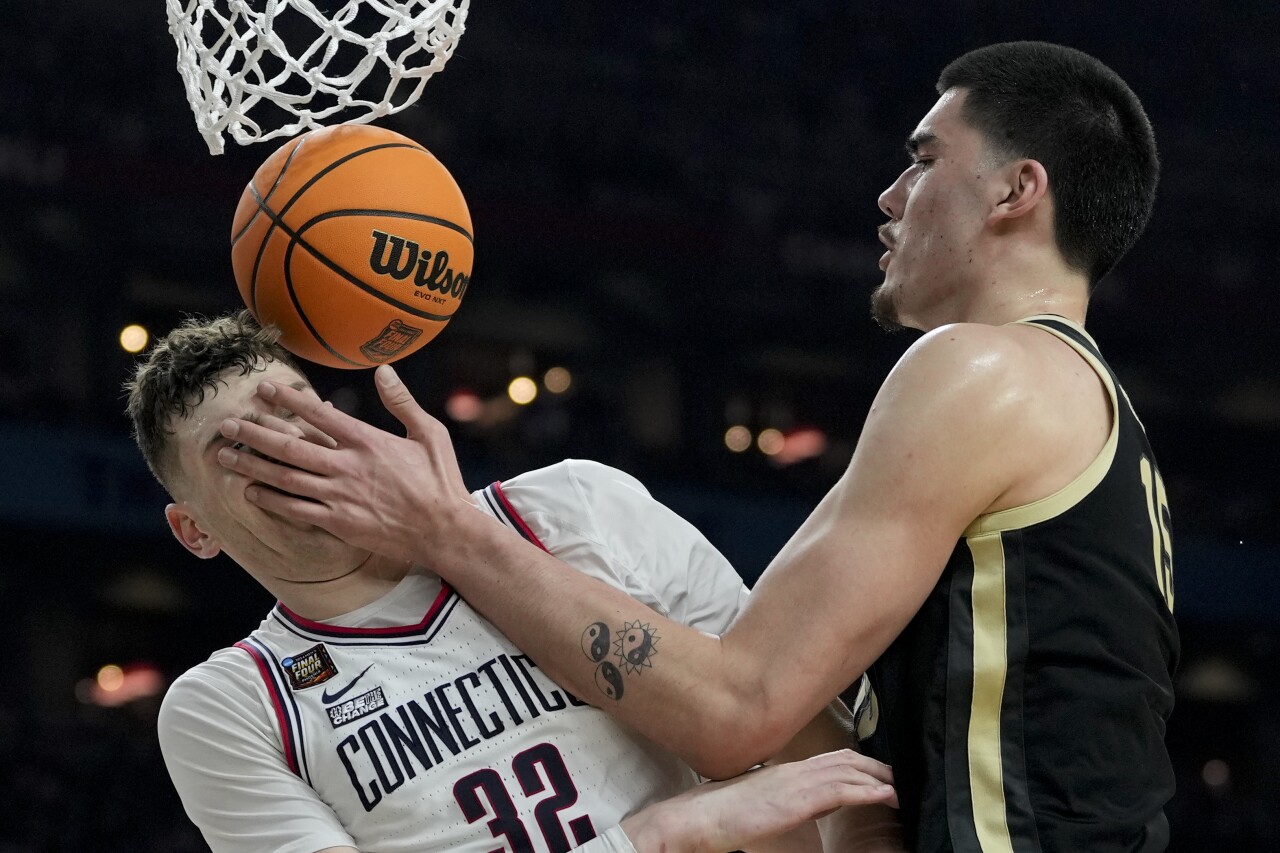 Purdue Boilermakers center Zach Edey fouls UConn Huskies center Donovan Clingan during second half of national championship game, April 8, 2024