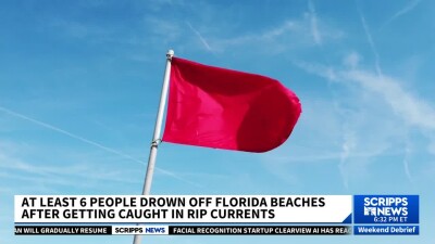 A red flag on a beach, warning of dangerous current conditions.