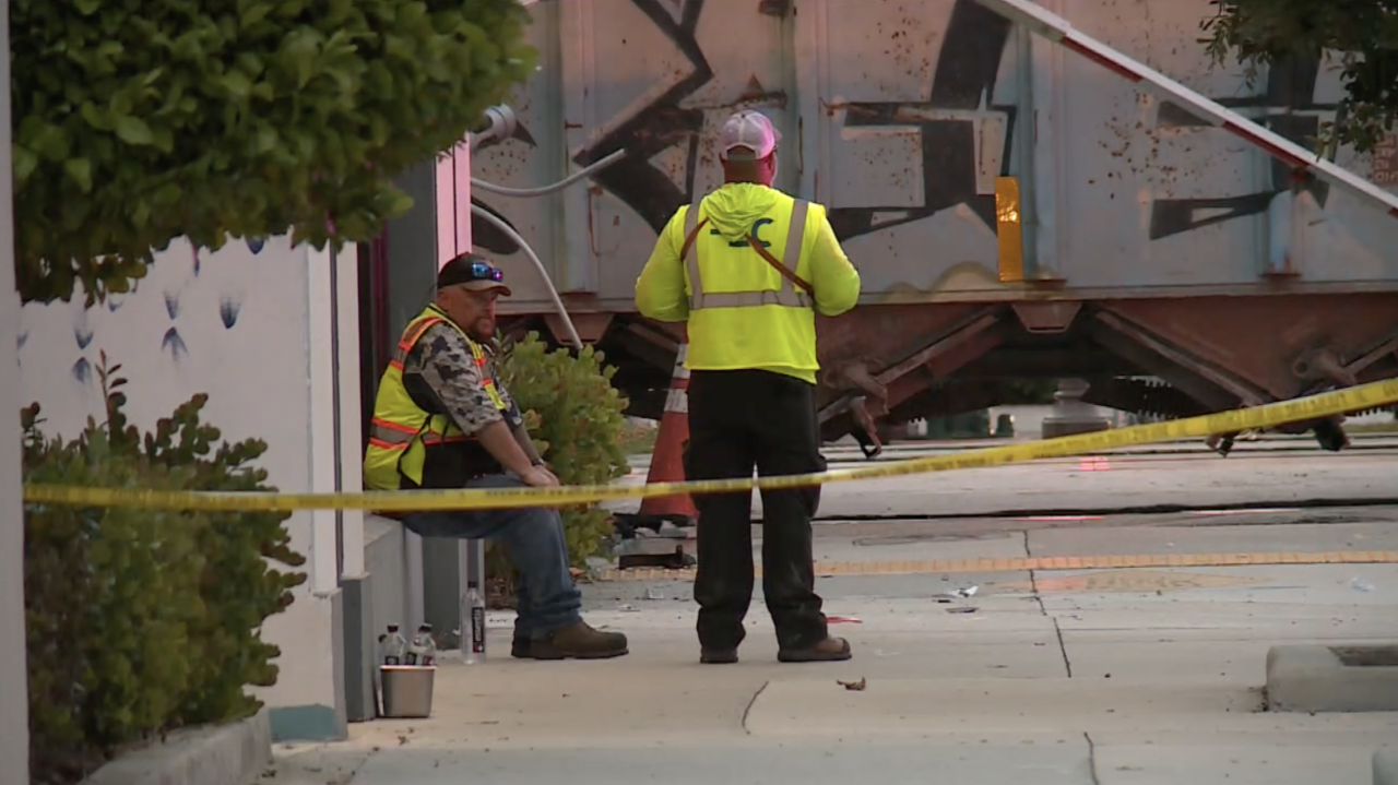 Freight train blocks railroad crossing in downtown West Palm Beach after crash, Oct. 12, 2022