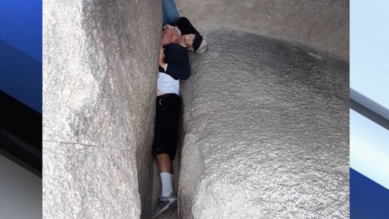 Phoenix fire crews rescue man stuck between two large rocks on South ...