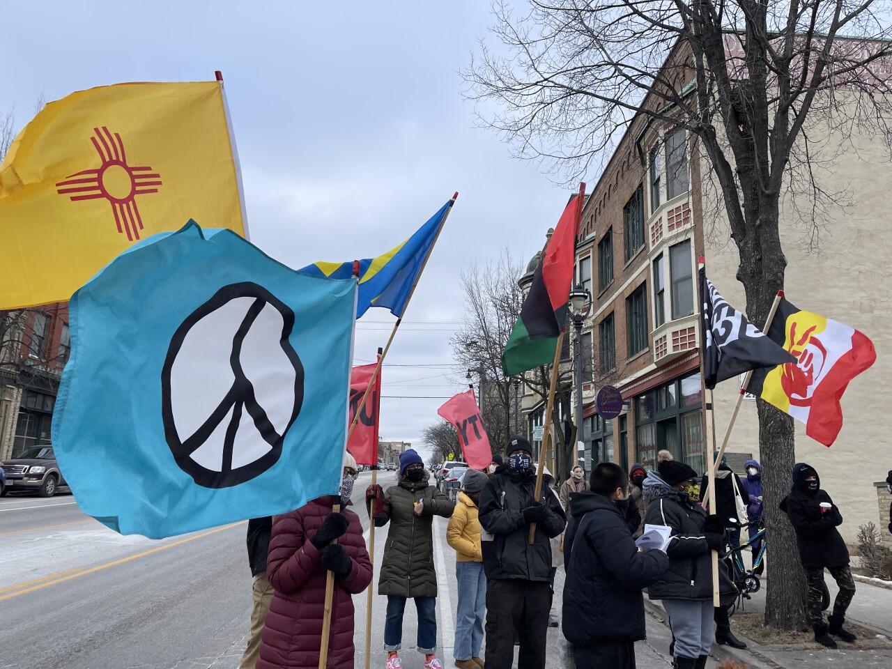 People holding up flags prior to the program beginning 