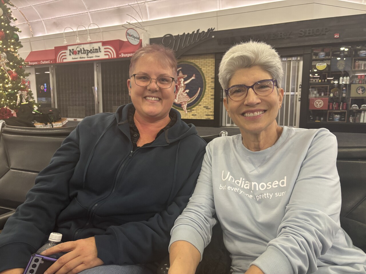 Tania Hunley waits with her mom Wendy Hunley at the Milwaukee Mitchell International Airport after Tania's flight was delayed