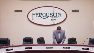 Mayor James Knowles packs up following a city council meeting in Ferguson, Missouri