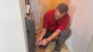 Certified inspector checks furnace during home inspection