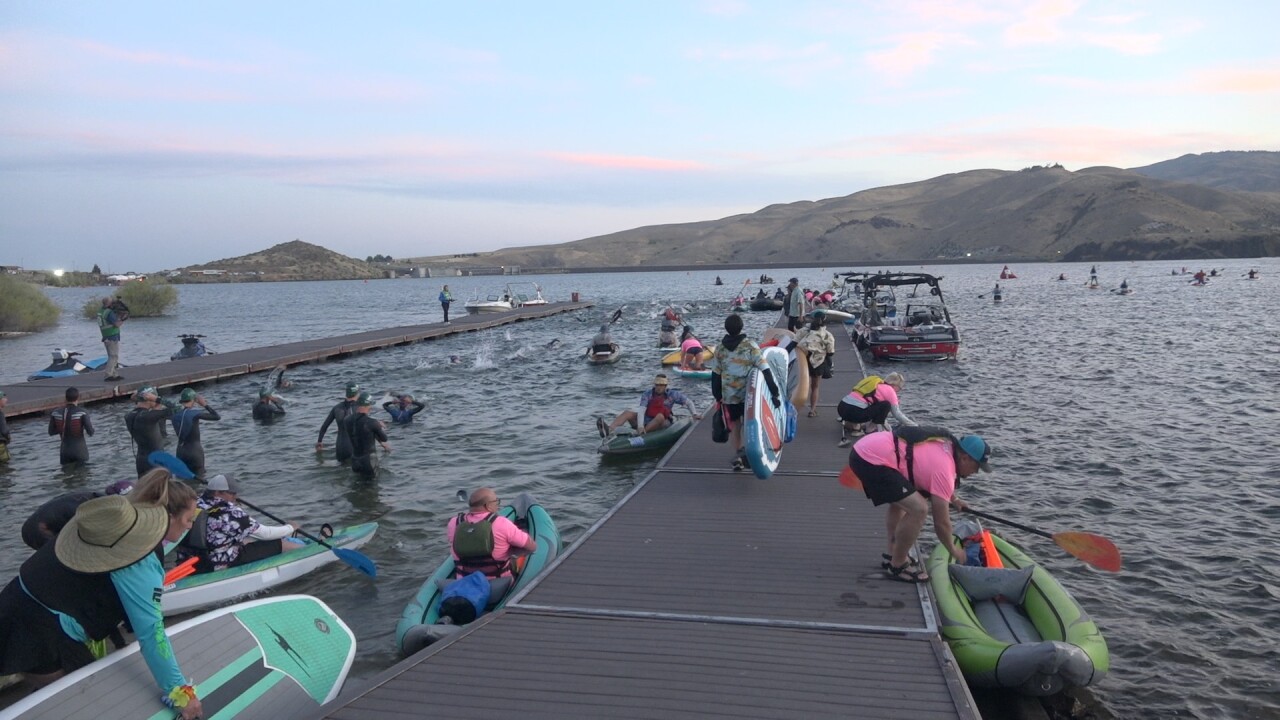 Volunteers head out on the water to help during the swim