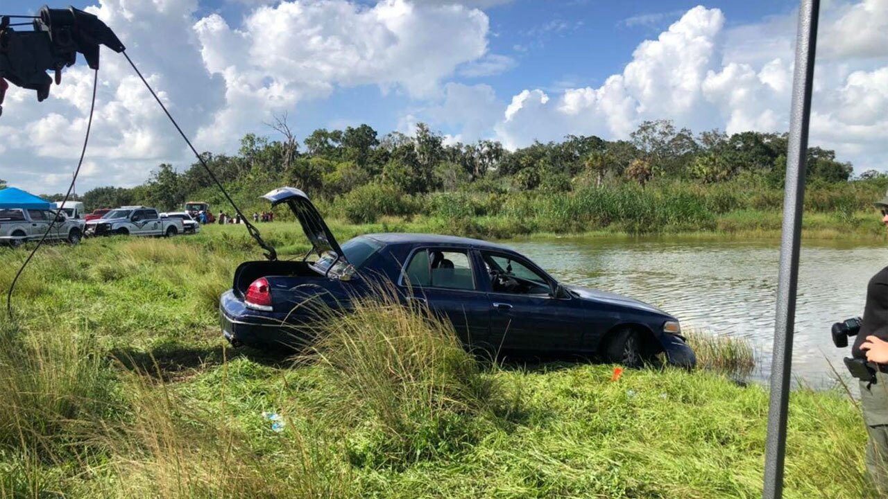 Crews retrieve a car from a pond near Indiantown, Florida, after two bodies were pulled from the waterway on July 25, 2022.
