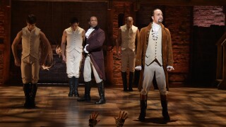 "Hamilton" actor and composer Lin-Manuel Miranda (R) is seen on stage during a performance of the musical at the Grammys.