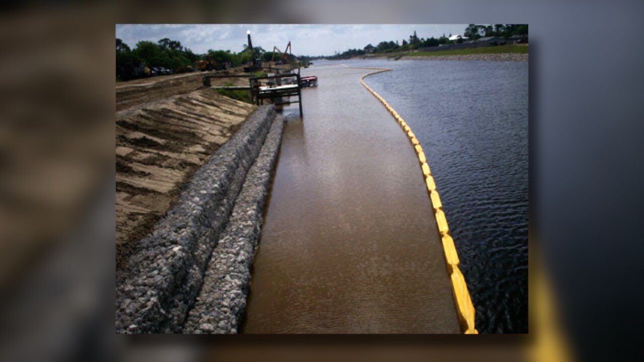 Turbidity curtains blocking sediment from entering a canal.