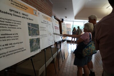 Neighbors looking at the potential options for bridge construction