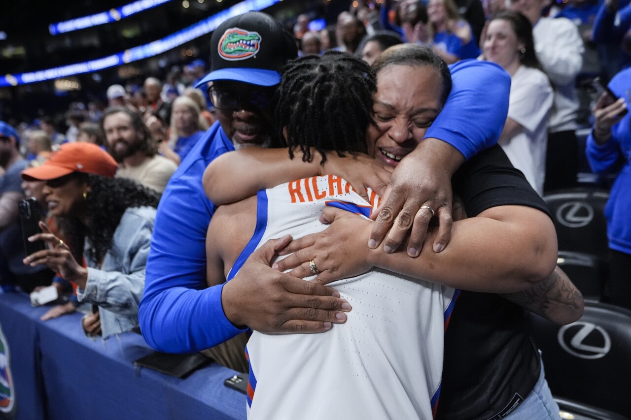 Florida guard Will Richard celebrates with his parents after the Gators defeeated Texas A&M in an NCAA college basketball game at the Southeastern Conference tournament Saturday, March 16, 2024, in Nashville, Tenn. (AP Photo/John Bazemore)