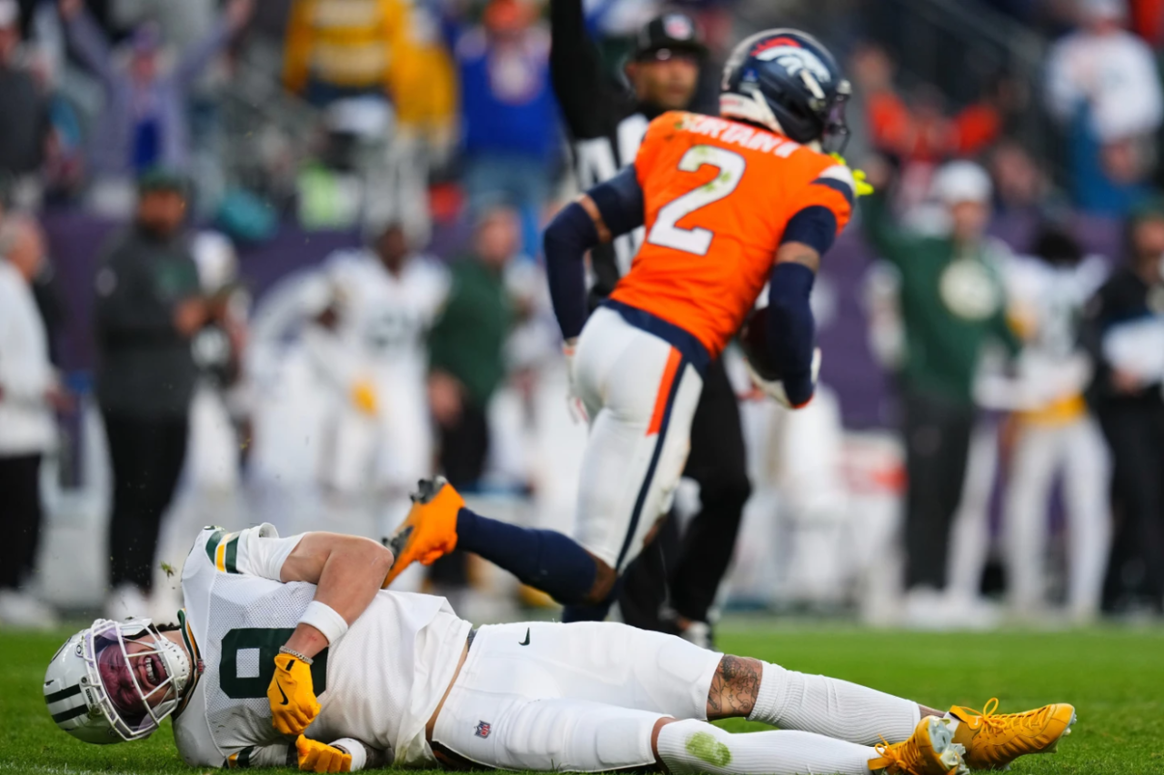 Green Bay Packers' Christian Watson is hurt after Denver Broncos' Pat Surtain II intercepts a pass during the second half of an NFL football game against the Denver Broncos Sunday, Dec. 14, 2025, in Denver, Co.