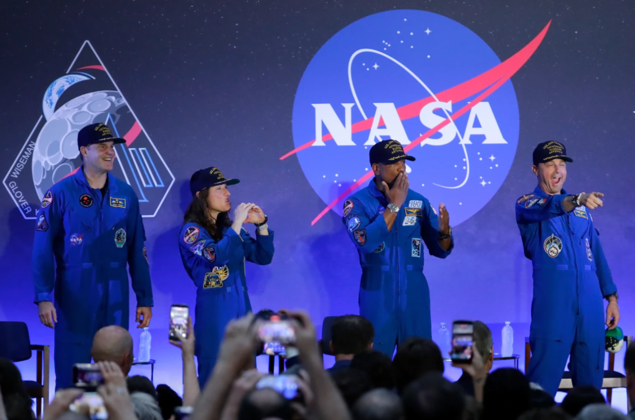 The Artemis II crew, from left, Jeremy Hansen, Christina Koch, Victor Glover and Reid Wiseman acknowledge the crowd as they take the stage during a crew return event Saturday, April 11, 2026, at Ellington Airforce Base in Houston.