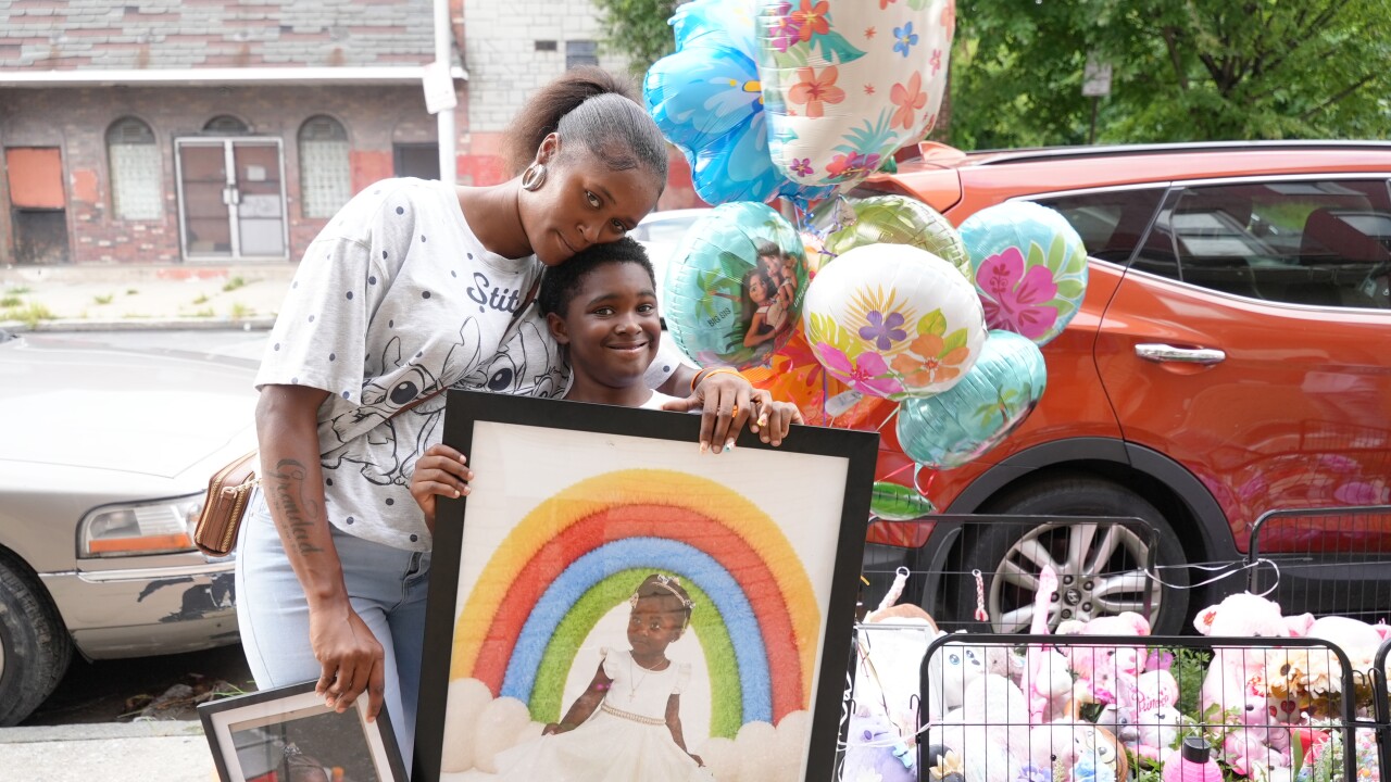 Nyjada Billy and her son in front of Jordan's memorial