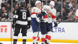 Florida Panthers left wing Brad Marchand, second from right, is helped off the ice by left wing Brady Tkachuk, second from left, and defenseman Niko Mikkola after he was injured as Los Angeles Kings defenseman Drew Doughty looks on during the second period of an NHL hockey game Tuesday, Oct. 6, 2026, in Los Angeles.