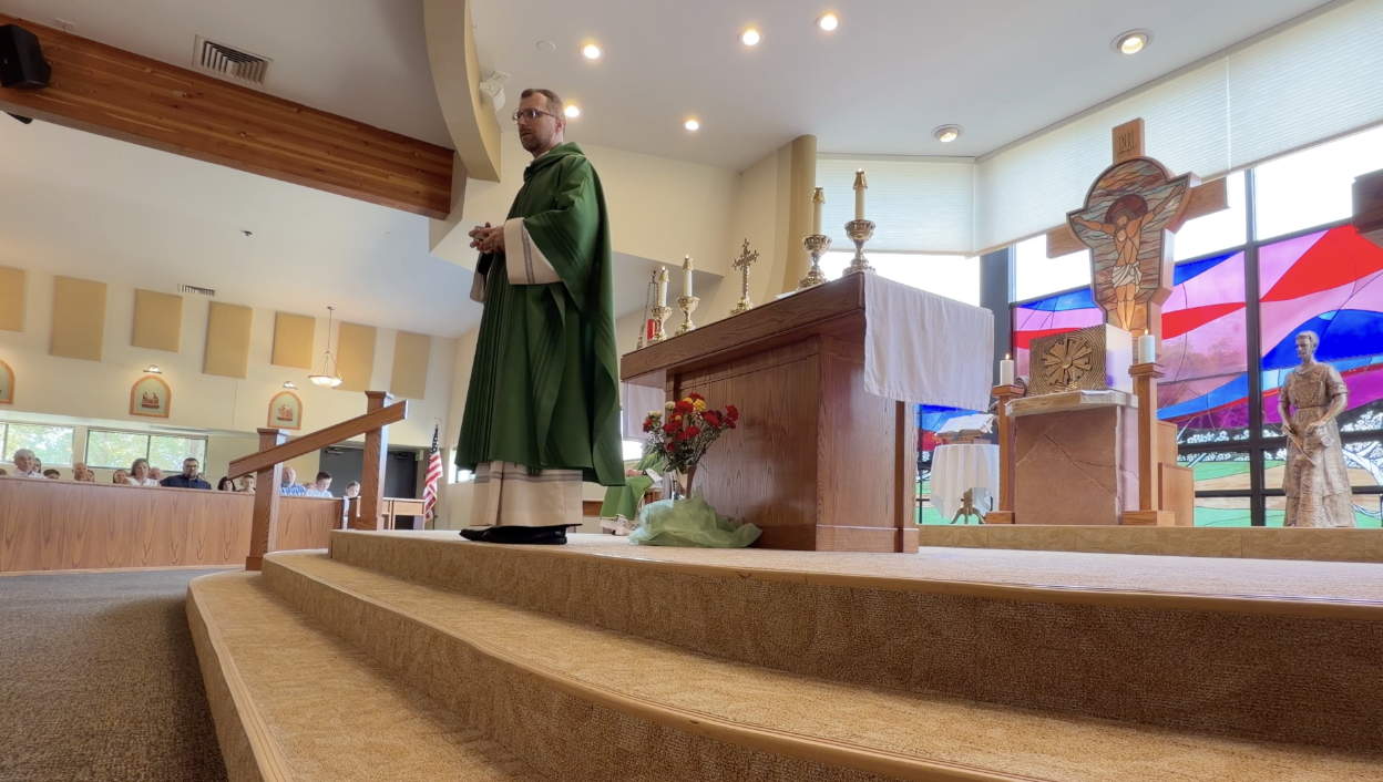 Father Witold presenting his homily at Christ On The Mountain Catholic Church in Lakewood