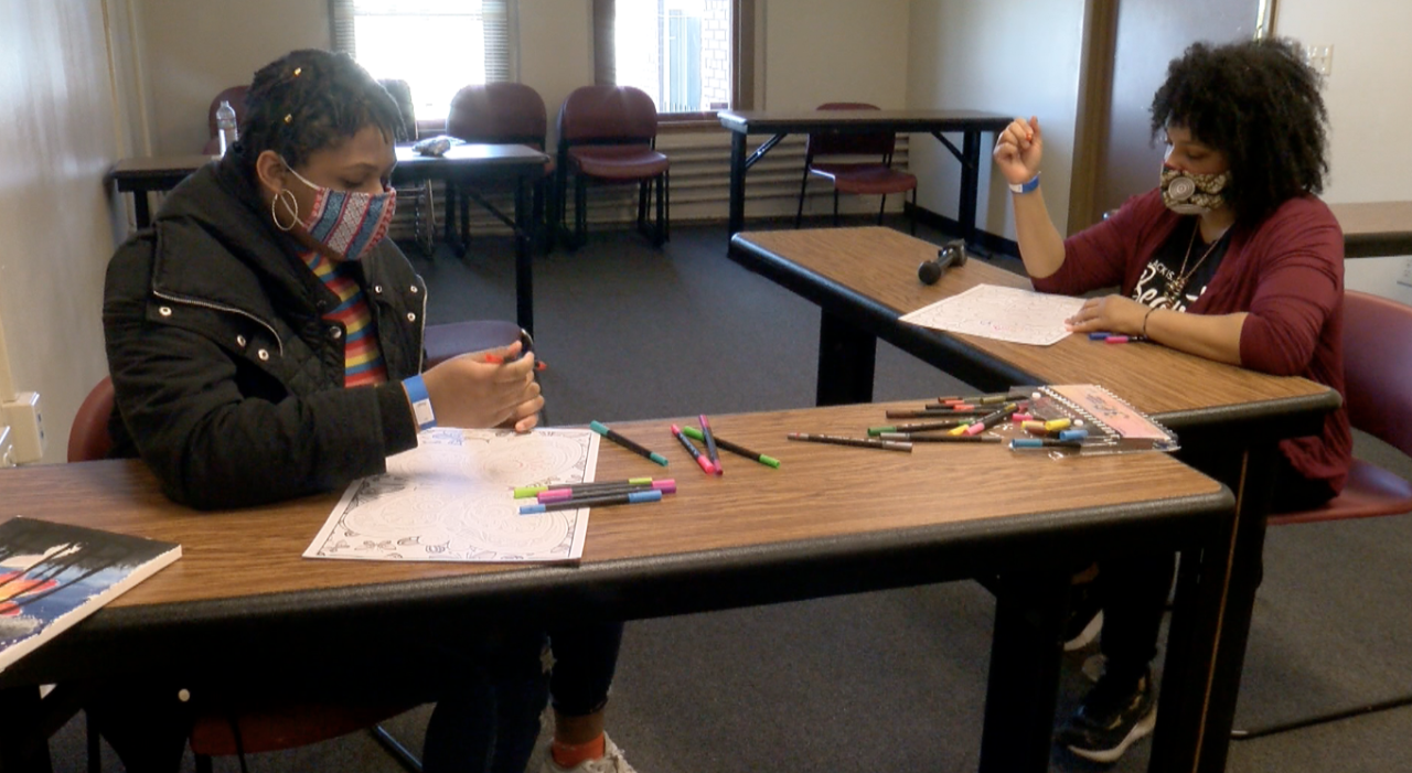 Golden Brown (mentee) and Whitney Bingham (mentor) work on art at Running Rebels