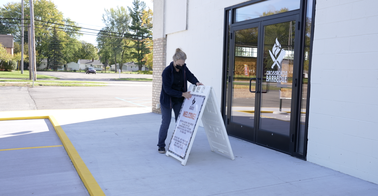 Ann Duchene is putting out a sign and getting ready for customers to arrive.