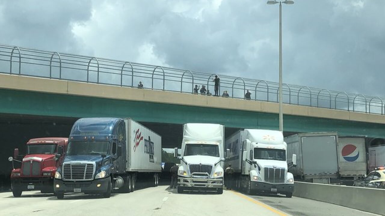 Truckers lined up under a Florida highway to save a man who threatened to jump